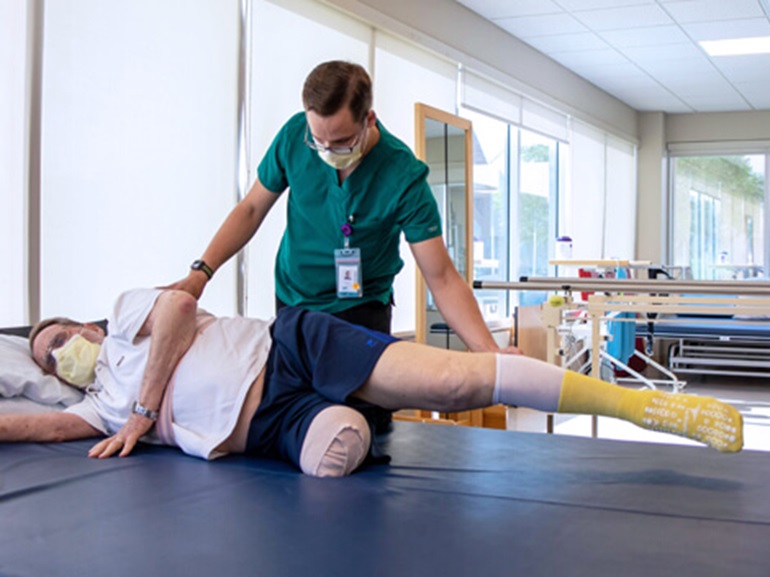 Person Being Stretched by Professional Learning How to Prepare for Prosthesis Wearing 
