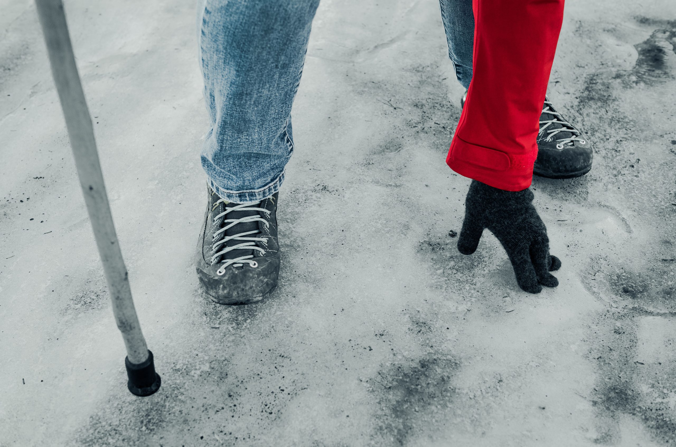 Person trying to stay upright on very slippery icy sidewalk.